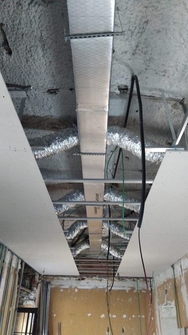Conductos de aire acondicionado aislados en el falso techo durante la instalación